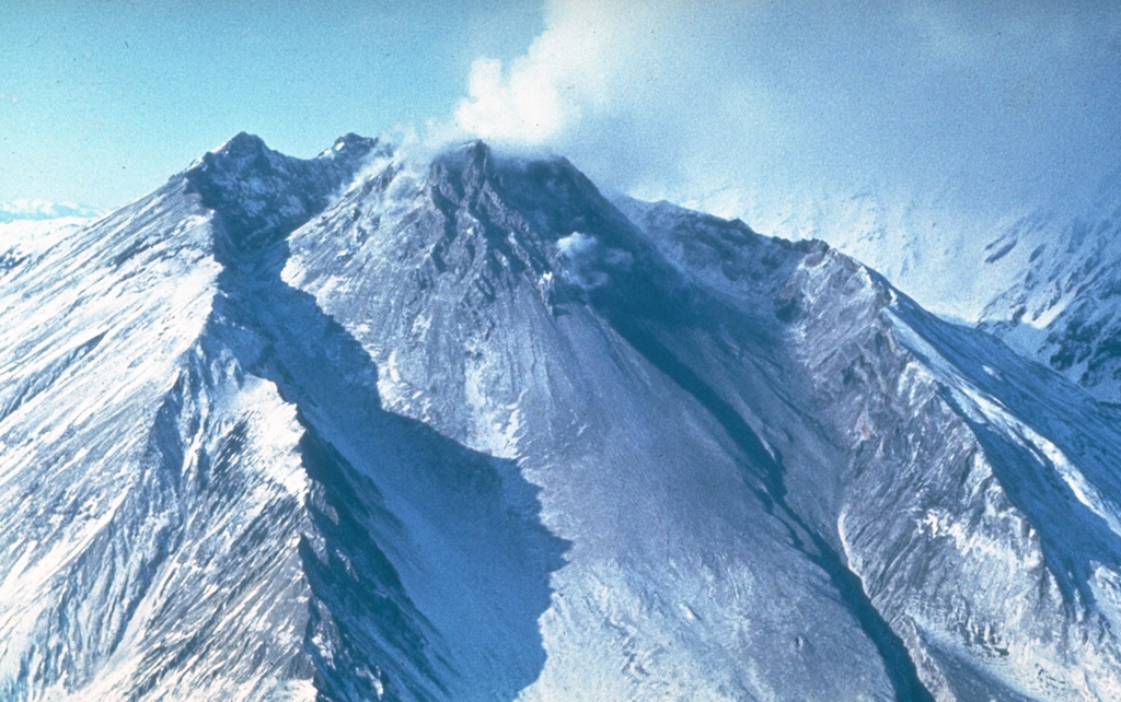 A lava dome fills much of the large horseshoe-shaped crater on the ESE side of Bezymianny in this late-1980s view from the SE. The crater formed during an eruption in 1955-56, which was similar to that of Mount St. Helens in 1980 with flank collapse and lateral blast components. Prior to this eruption Bezymianny had been considered extinct. Subsequent episodic lava dome growth, accompanied by intermittent explosive activity and pyroclastic flows, has largely filled the 1956 crater. Photo by Yuri Doubik (Institute of Volcanology, Petropavlovsk).
