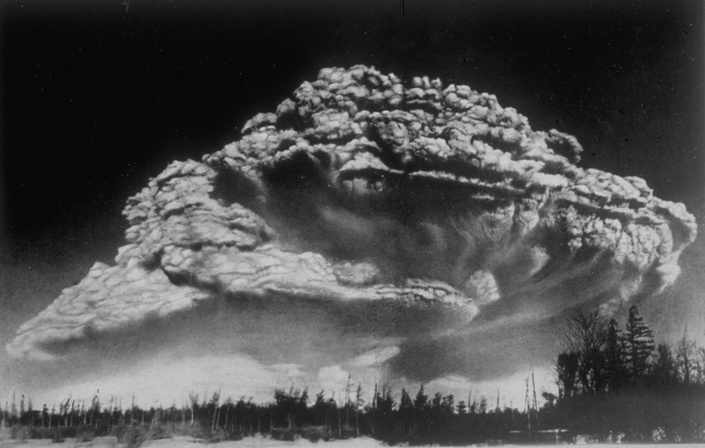 Following a period of explosive eruptions and lava-dome growth beginning in October 1955, a major explosive eruption took place on 30 March 1956 at Bezymianny volcano in Kamchatka. The Plinian eruption, seen here from 100 km W, produced a 40-km-high ash column, pyroclastic flow to a distance of 18 km, lateral blast, and a debris avalanche when the summit of the volcano collapsed. Photo by I. V. Yerov, 1956 (courtesy of G.S. Gorshkov, published in Green and Short, 1971).