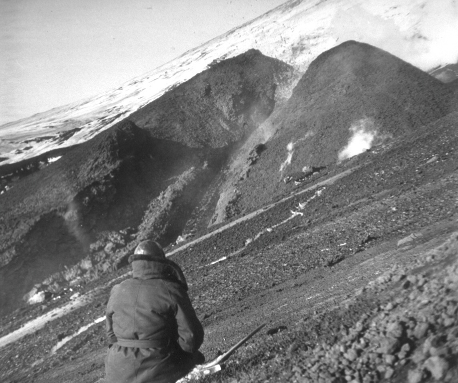 Following renewed explosive activity in the Klyuchevskoy summit crater starting on 8 April 1974, an eruption began on 23 August from a vent on the SW flank. This was the highest flank vent location to date in Klyuchevskoy’s recorded history. This photo shows lava fountaining and effusion of a lava flow from the SW-flank vent. The eruption continued until the end of the year. Photo by N. Smelov, 1974 (Institute of Volcanology, Petropavlovsk).