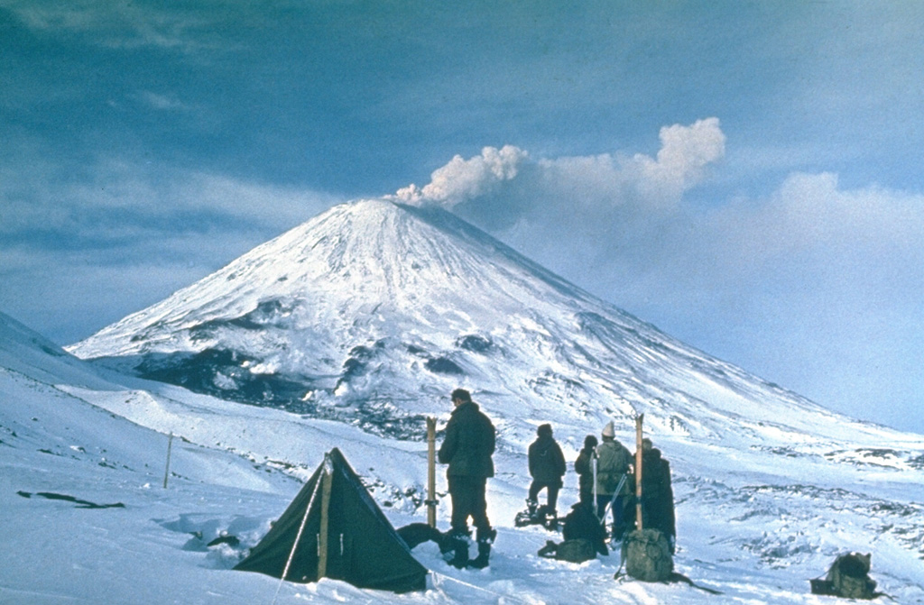 An ash plume drifts from the summit of Klyuchevskoy in 1974 above volcanologists at a field camp of the Institute of Volcanology in Petropavlovsk. Renewed explosive summit crater activity began 8 April and lava fountaining started on 18 May. Summit activity was followed by an eruption on the SW flank on 23 August. Frequent eruptions have occurred at Klyuchevskoy from both summit and flank vents.   Photo by Yuri Doubik, 1974 (Institute of Volcanology, Petropavlovsk).