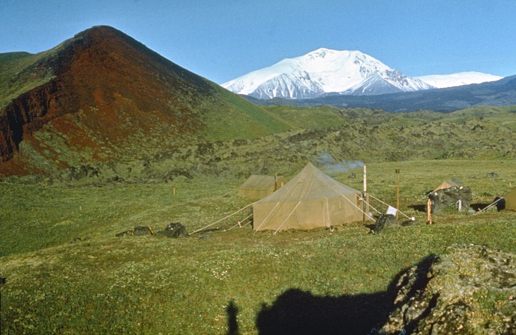 Ushkovsky is a large compound volcanic massif located at the NW end of the Klyuchevskaya volcano group. Seen here from the NW, it consists of the flat-topped Ushkovsky (far right), which is capped by an ice-filled 4.5 x 5.5 km caldera, and the adjacent higher Krestovsky peak (center). Numerous scoria cones have formed on its flanks.  Photo by E.Y. Zhdanova (courtesy of Oleg Volynets, Institute of Volcanology, Petropavlovsk).