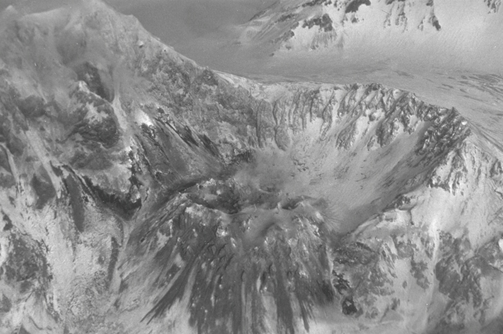 The lava dome in the Sheveluch crater is seen from the north on 2 February 1990, four days after a series of explosions began. The explosions created funnel-shaped vents at the dome summit up to a few tens of meters wide. Subsequent explosions occurred on 6 February, 2, 5, and 29-30 March, 26 and 29 April, and 4 August 1990. The latter eruption was the most vigorous since 1984, producing a 6-km-high ash plume, lahars, and block-and-ash flows that traveled 2 km. Photo by B.V. Ivanov, 1990 (Institute of Volcanology, Petropavlovsk).