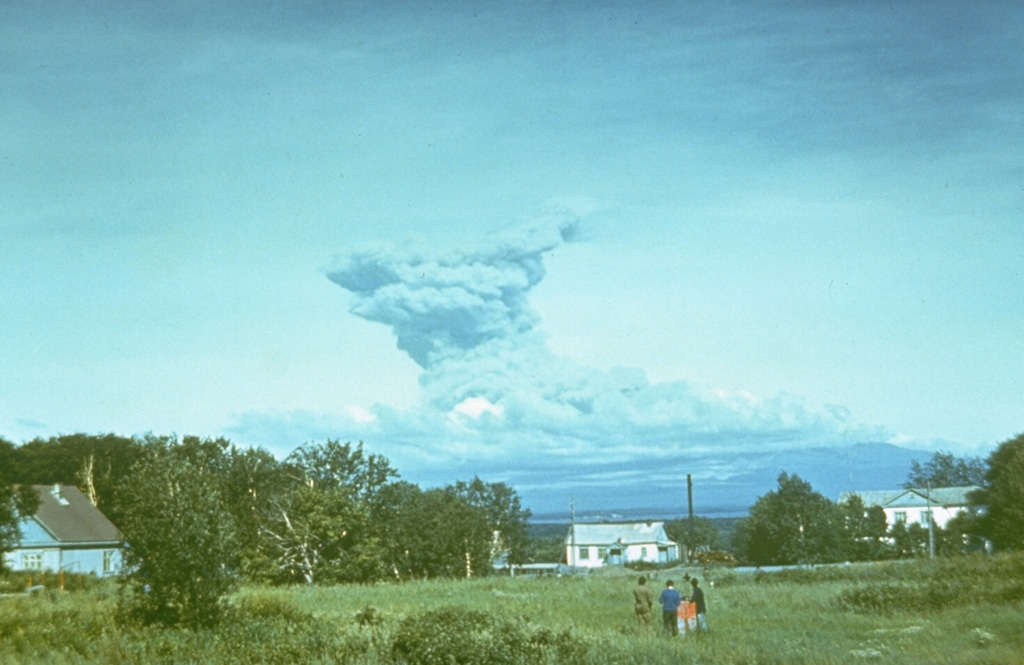 An ash plume at Sheveluch volcano is observed in 1984 from the town of Klyuchi, 50 km to the SW. The eruption originated from a lava dome that began growing in 1980 within a crater that formed during flank collapse in 1964. No change in the geometry of the lava dome was noticed from 1983 until the onset of the 1984 eruption. Photo by Kamchatka Volcanic Eruptions Response Team, 1984 (courtesy of Dan Miller, U.S. Geological Survey).