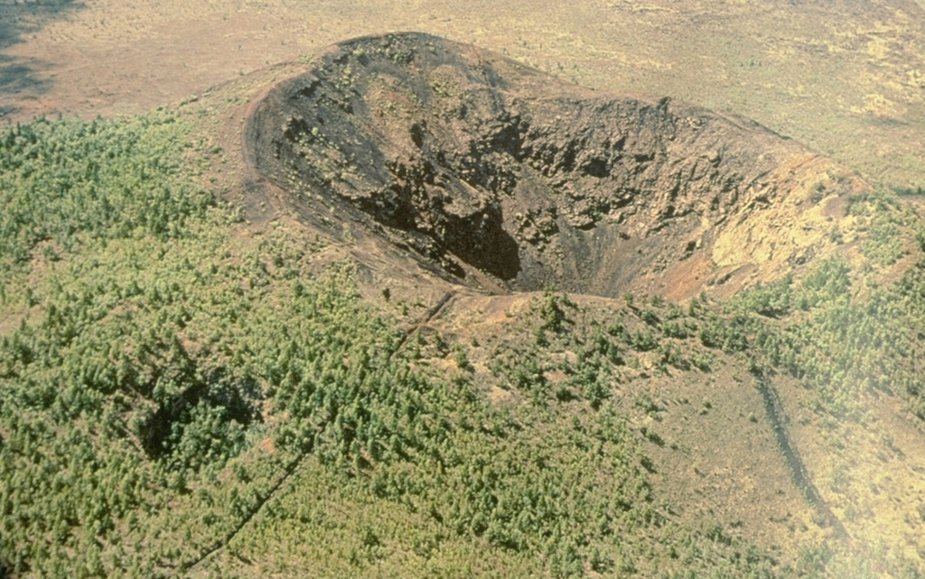 Laoheishan is one of two scoria cones that formed during the 1719-21 eruption of the Wudalianchi volcanic field and contains a 350-m-wide, 145-m-deep summit crater. A smaller vegetated crater on the NE flank can be seen to the lower left. Laoheishan formed a large portion of an extensive lava field that surrounds it and Huoshaoshan, the other scoria cone that formed during the eruption. Photo courtesy of Jim Whitford-Stark, Sul Ross State University, Texas (published in Feng et al., 1979).