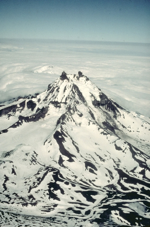 Isanotski volcano, sometimes referred to as "Ragged Jack," has been extensively dissected by glaciers.  Although historical eruptions in the 18th and 19th centuries have been attributed to Isanotski, these reports from an infrequently visited region with notoriously poor weather must be considered somewhat suspect. Copyrighted photo by Katia and Maurice Krafft, 1978.