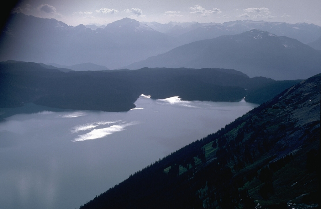 The low ridge in the center of the photo consists of early Holocene lava flows that originated from Clinker Peak on Mount Price to the south (out of view to the left). The lava flows ponded against the retreating continental glacier that filled the Cheakamus River valley to a depth of 1 km and formed a barrier that created Garibaldi Lake. Photo by Lee Siebert, 1983 (Smithsonian Institution).