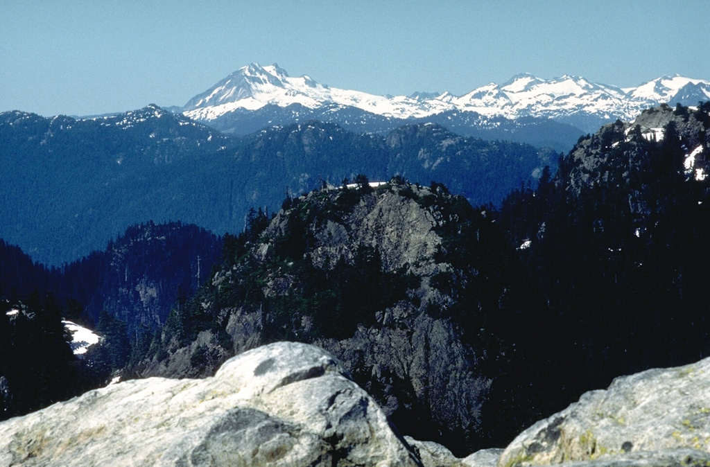 Mount Garibaldi is to the left in the background. In the foreground are glacially eroded granitic rocks of the Coast Range Batholith that extend south to the Mount Seymour area in the foreground, immediately north of the city of Vancouver.  Photo by Lee Siebert (Smithsonian Institution).