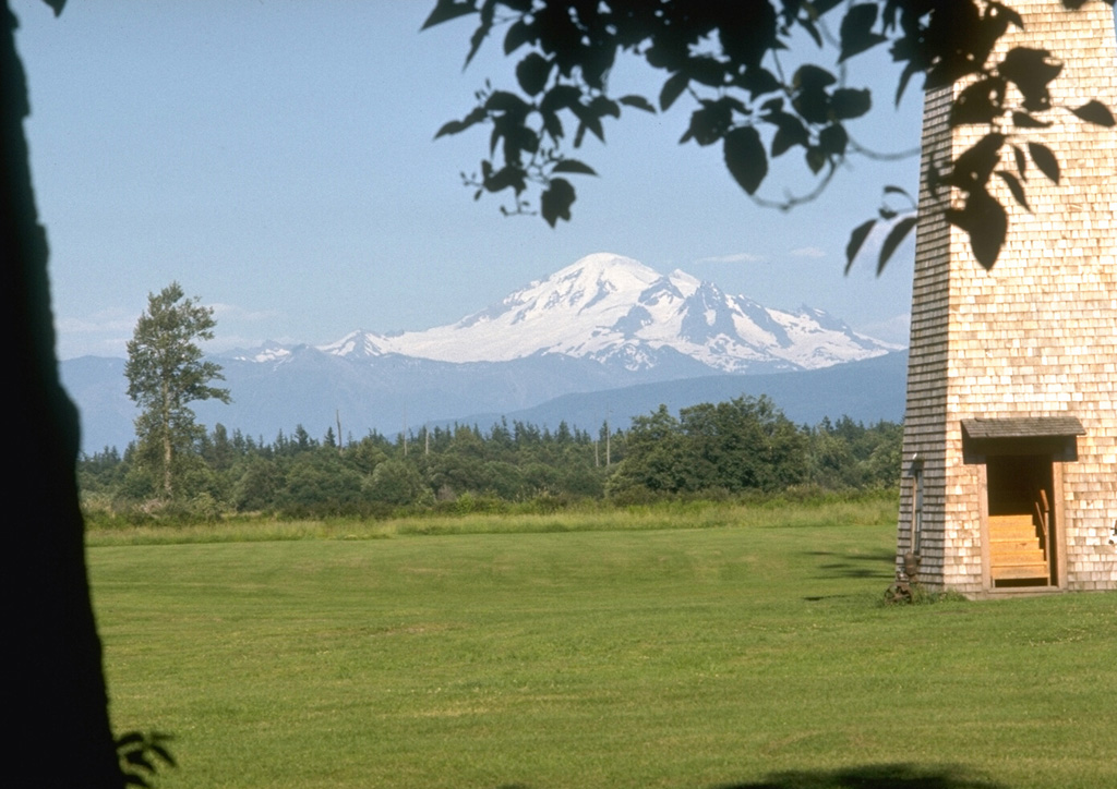 Mount Baker, seen here from the dairy farms of Whatcom County to the west, is a prominent landmark visible from much of NW Washington and SW British Columbia. Nineteenth-century eruptions were visible from as far away as Victoria Island across the Puget Sound. Photo by Lee Siebert, 1972 (Smithsonian Institution).