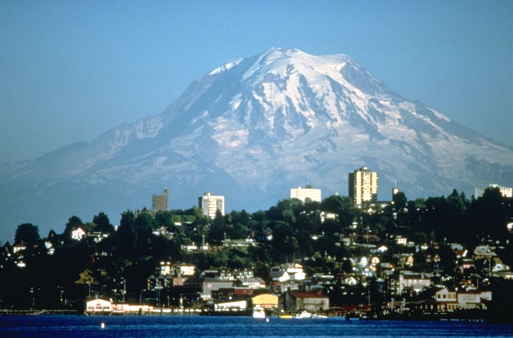 Mount Rainier, the highest peak in the Cascade Range, towers above the city of Tacoma and forms a prominent landmark seen from much of central Washington. Periodic collapse of the volcano during the past ten thousand years has produced debris avalanches and lahars that have reached the Puget Sound at the present locations of the cities of Tacoma and Seattle. Photo by Lyn Topinka (U.S. Geological Survey).