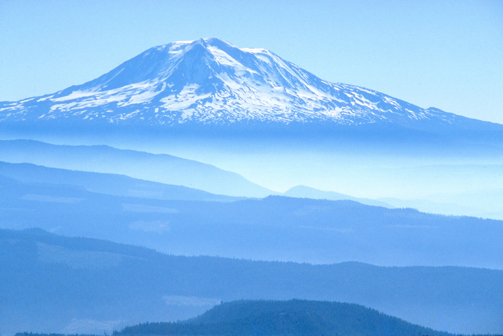Mount Adams is seen in this view from Mount St. Helens to the west. Eruptive activity continued into the Holocene from both summit and vents on the N, NW, S and E flanks. Photo by Lee Siebert, 1979 (Smithsonian Institution).