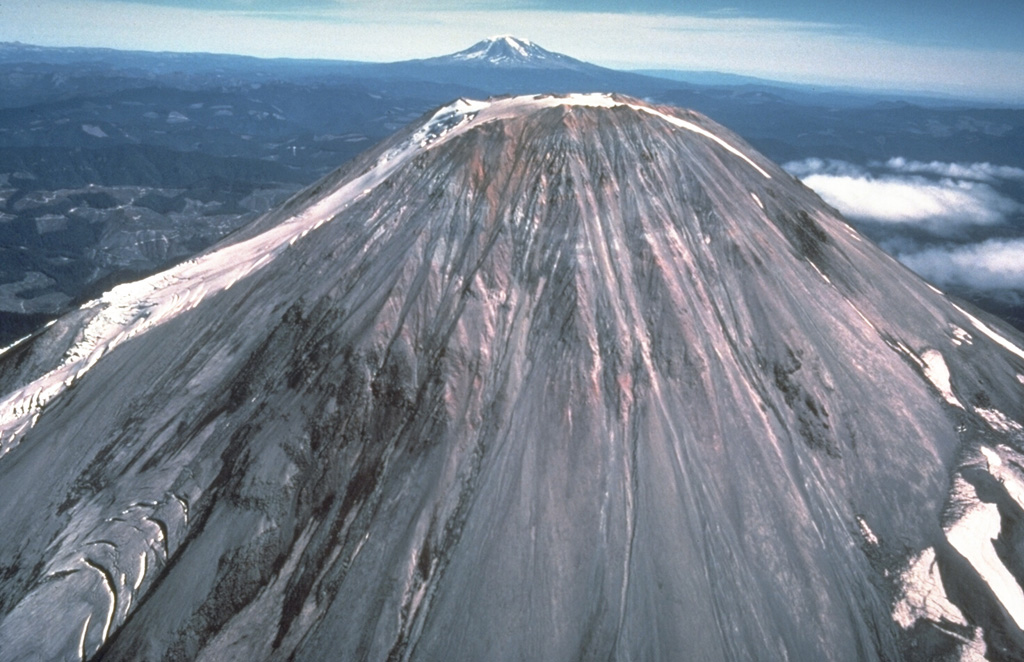 Rocks of the pre-1980 summit lava dome are visible in this 1978 photo of the west side of Mount St. Helens with Mount Adams in the background. Growth of the Summit Dome occurred between about 1630-1720 CE at the end of the Kalama eruptive period. The dome produced pyroclastic flows and lahars down all the flanks. Photo by Rick Hoblitt, 1978 (U.S. Geological Survey).