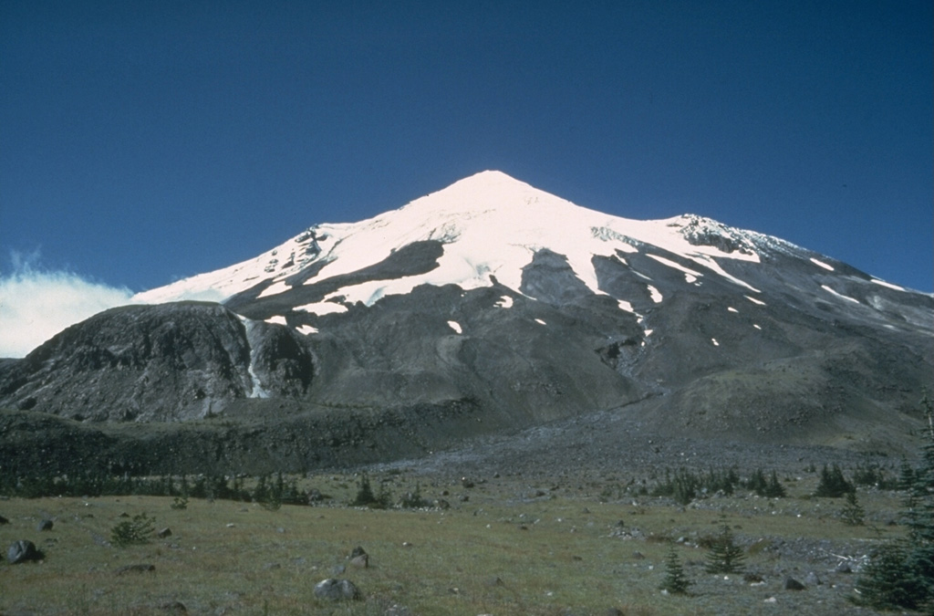 East Dome, the rounded lava dome to the left, is seen in this 1978 view from the Plains of Abraham on the NE side of Mount St. Helens. An explosive eruption accompanied emplacement of the dome on the lower E flank. This eruption took place near the during the Sugar Bowl Eruptive Period during 900 to 850 CE. Photo by Rick Hoblitt, 1978 (U.S. Geological Survey).