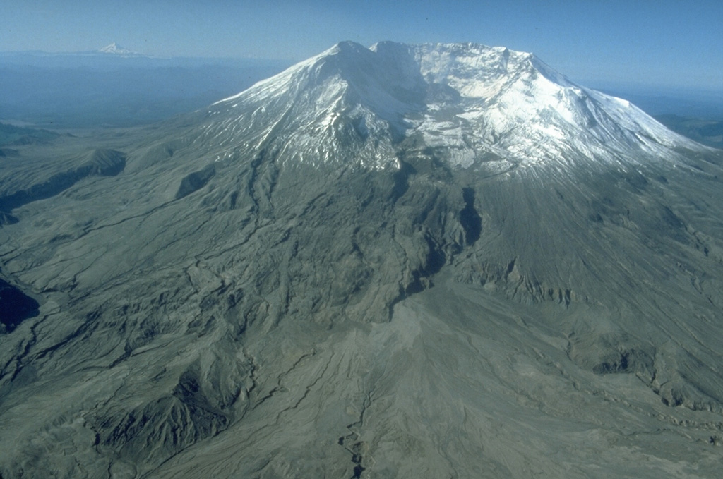 The 2 x 3.5 km horseshoe-shaped crater at Mount St. Helens is typical of scarps formed by massive landslides. On 18 May 1980 the upper 400 m of the summit was removed, leaving the crater open to the N. This event was the world's largest landslide during historical time. The missing portion of the volcano transitioned into the debris avalanche deposits filling the North Fork Toutle River below the volcano. Photo by Terry Leighley, 1981 (U.S. Geological Survey).