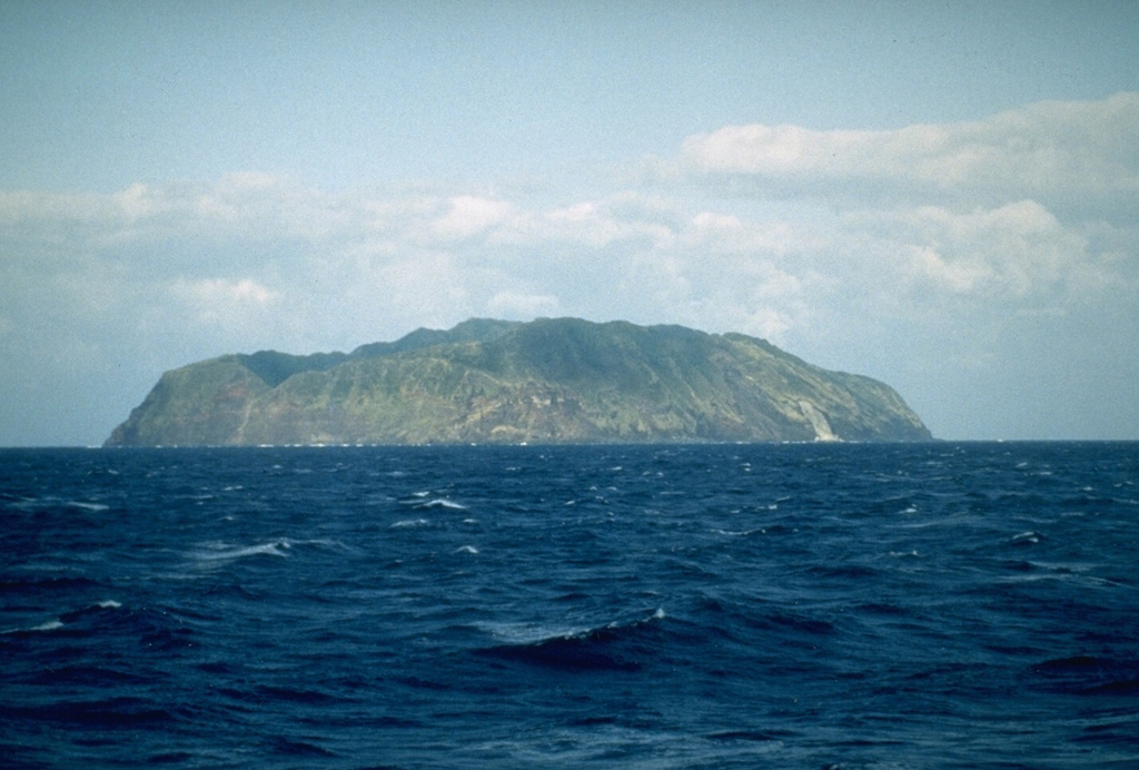 The 2.5 x 3.5 km island of Aogashima, seen here from the SE, is located in the central Izu Islands. It is has steep cliffs on all sides and contains a small 1.5 x 1.7 km caldera. Two cones were formed inside the caldera during the latest eruption from 1780 to 1785. Photo by Richard Fiske (Smithsonian Institution).