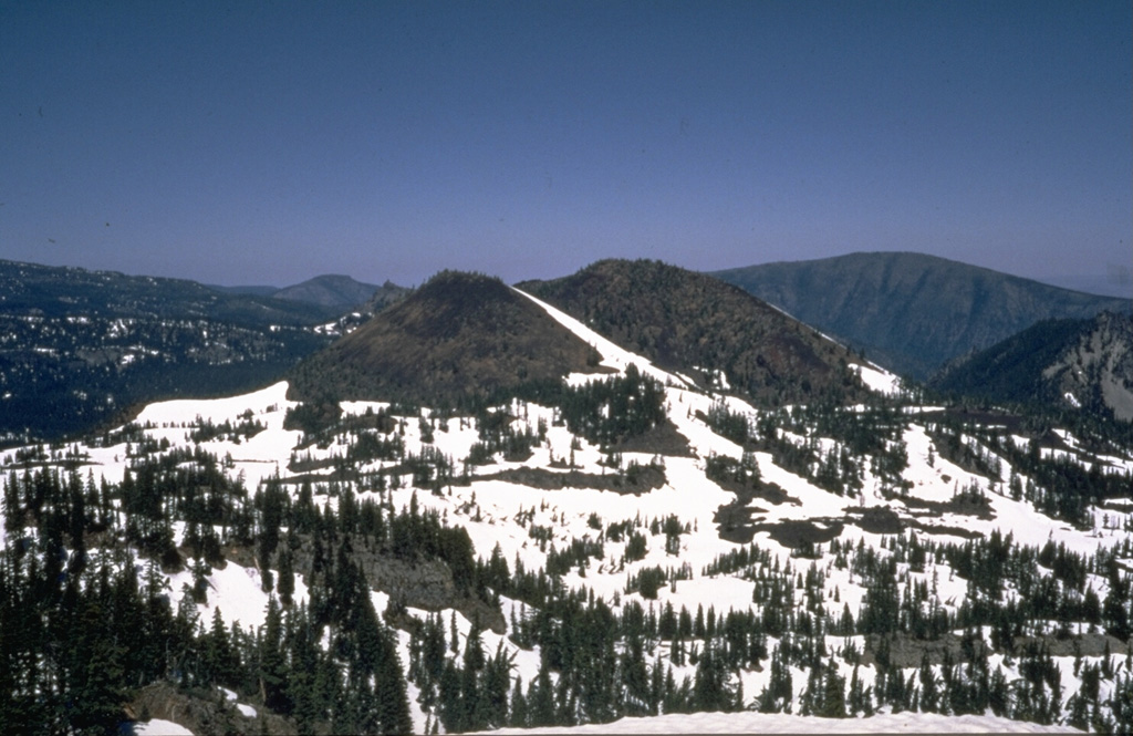 Forked Butte, viewed here from the SW, is a Holocene scoria cone south of Mount Jefferson that produced an 8-km-long lava flow down Cabot Creek about 6,500 years ago. Forked Butte is one of three cones south of Jefferson that have produced Holocene lava flows. Photo by Willie Scott, 1973 (U.S. Geological Survey).