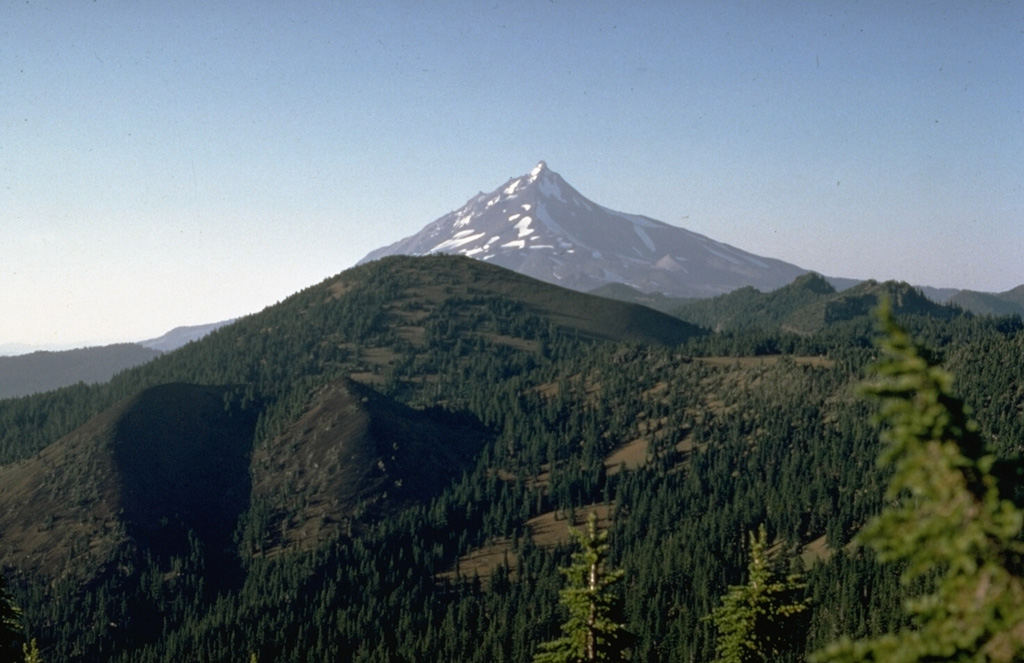 The latest eruption in the Mount Jefferson area occurred from the scoria cone at the lower left on the flank of South Cinder Peak in the center of the photo. The eruption, dated to about 1,000 years ago, formed the cone and produced a lava flow that split into two lobes. One traveled to the NW, and the other flowed 3.5 km W into Marion Lake. Photo by Willie Scott, 1973 (U.S. Geological Survey).