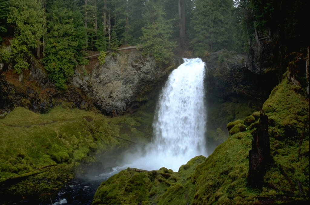 Sahalie Falls formed when lava flows erupted about 3,000 years ago from the Sand Mountain volcanic field traveled to the west, blocking the channel of the ancestral McKenzie River.  Photo by Lee Siebert, 1995 (Smithsonian Institution).
