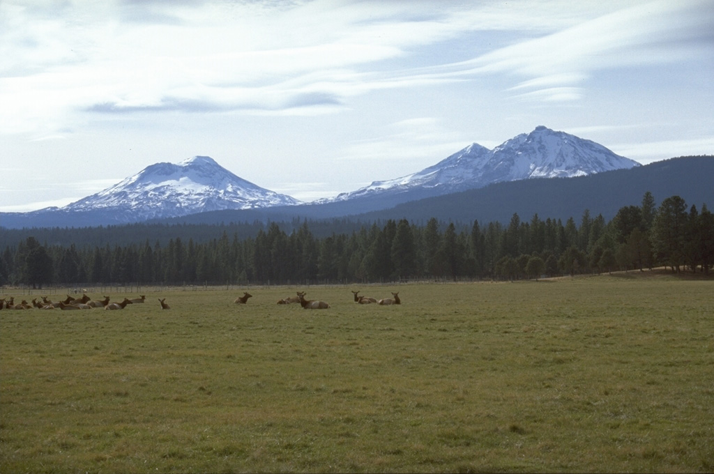 The Three Sisters volcanoes form the most prominent landmarks of the central Oregon Cascades. All three volcanoes ceased erupting during the Pleistocene, but flank vents of South Sister to the left and North Sister to the right have erupted in the past few thousand years. Photo by Lee Siebert, 1995 (Smithsonian Institution).
