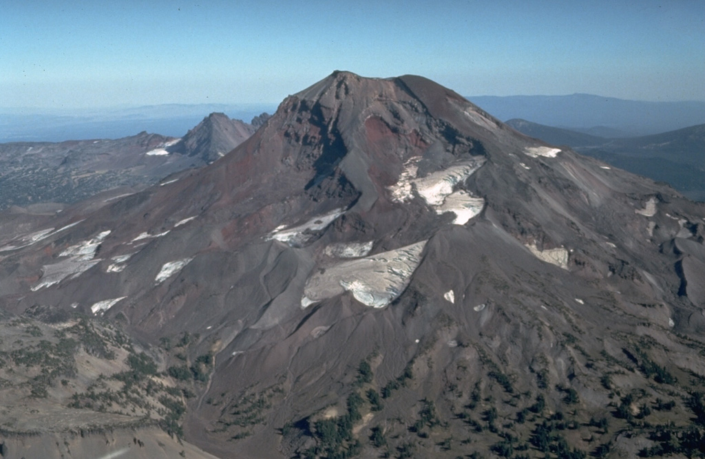 South Sister, seen here from the south, still contains a preserved summit crater although glaciers have eroded the flanks. Holocene eruptions have occurred from flank vents. Photo by Dan Miller, 1977 (U.S. Geological Survey).