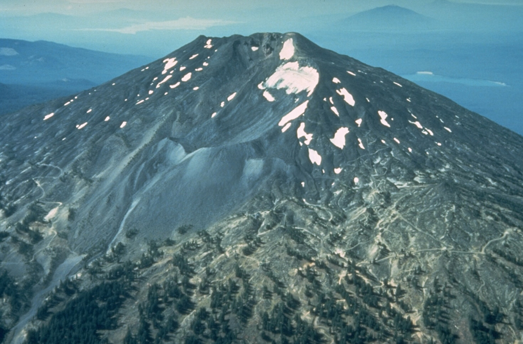 Mount Bachelor, SW of Bend, Oregon, is seen here from the north with a neoglacial moraine in the center. No known summit eruptions have occurred during the Holocene, although it was active until the latest Pleistocene and a N-flank vent produced a series of lava flows immediately preceding the eruption of the Mazama ash about 7,700 years ago. Photo by Willie Scott, 1981 (U.S. Geological Survey).
