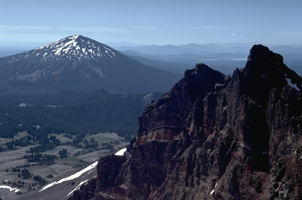 Mount Bachelor, seen here from the summit of Broken Top volcano to the north, was constructed during the late Pleistocene. Holocene eruptions occurred at a cone on the north flank.  Photo by Lee Siebert, 1982 (Smithsonian Institution).