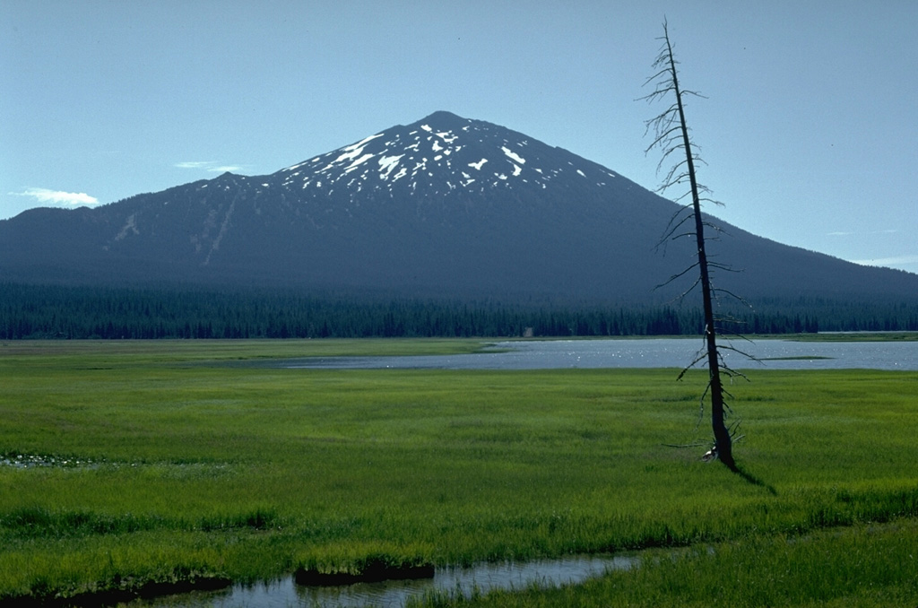 Mount Bachelor is seen here beyond Sparks Lake to the west. It is a late Pleistocene-to-Holocene stratovolcano at the northern end of a 25-km-long chain of scoria cones and small shield volcanoes.  Photo by Lee Siebert, 1982 (Smithsonian Institution).