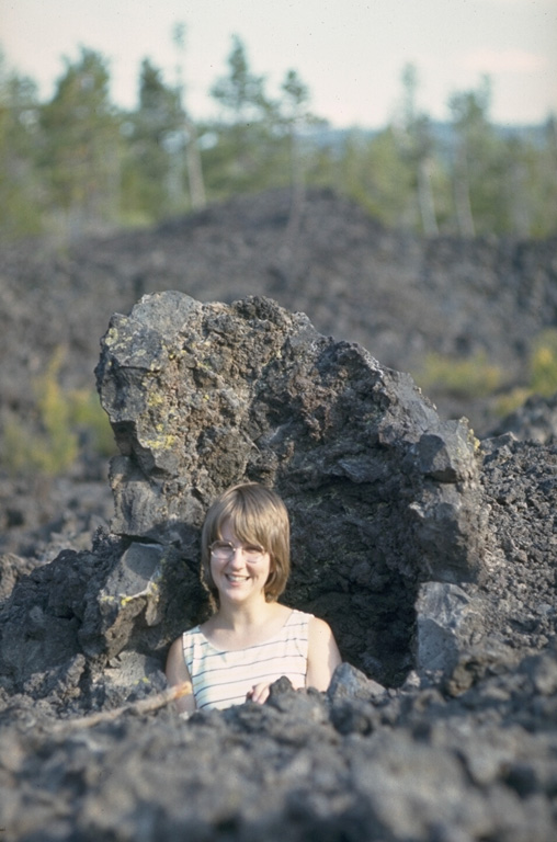 The Lava Cast Forest lava flow on the NW flank of Newberry formed about 7,000 years ago. It contains hollow tree molds that stand above the surface of the flow. These features formed when flowing lava chilled around standing tree trunks that subsequently burned from the heat of the lava. Horizontal tree molds formed around trees that had either previously fallen or were toppled by the advancing lava flow.  Photo by Lee Siebert, 1972 (Smithsonian Institution).