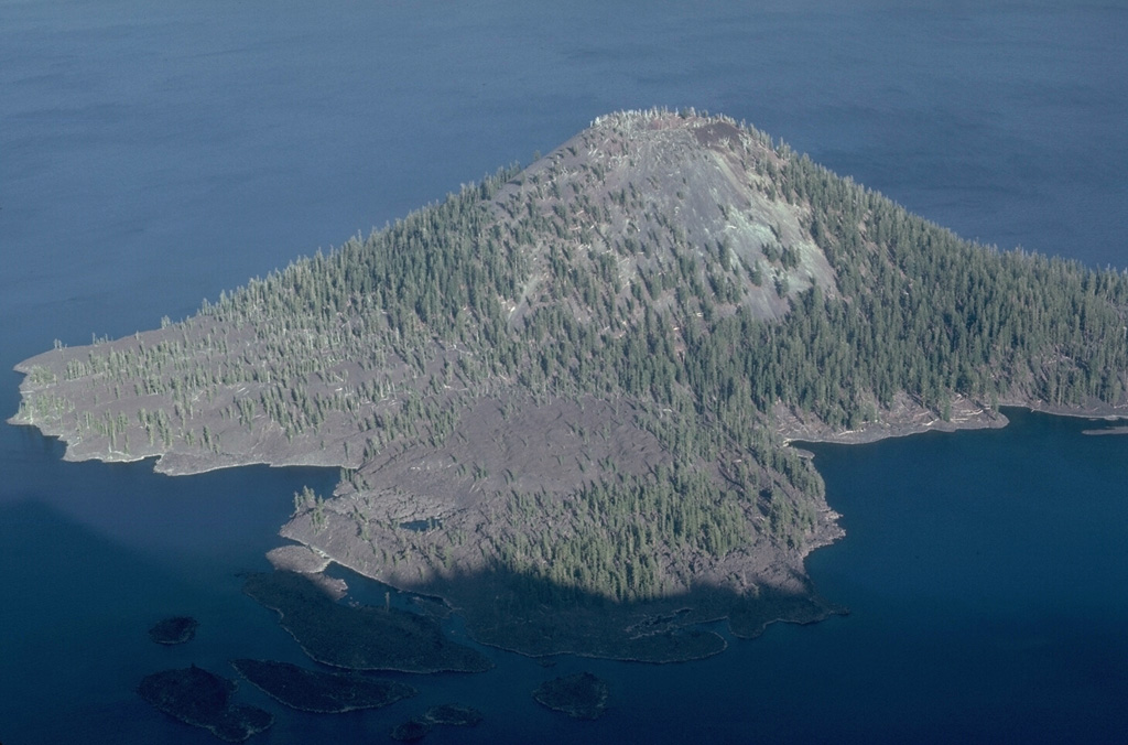 The Wizard Island scoria cone has a symmetrical 90-m-wide crater at its summit, formed above the west floor of Oregon's Crater Lake caldera within a few hundred years of caldera formation. A lava flow created the peninsula in the foreground on the NW side of the cone, which forms a small island on the west side of Crater Lake. Photo by Lee Siebert, 1981 (Smithsonian Institution).