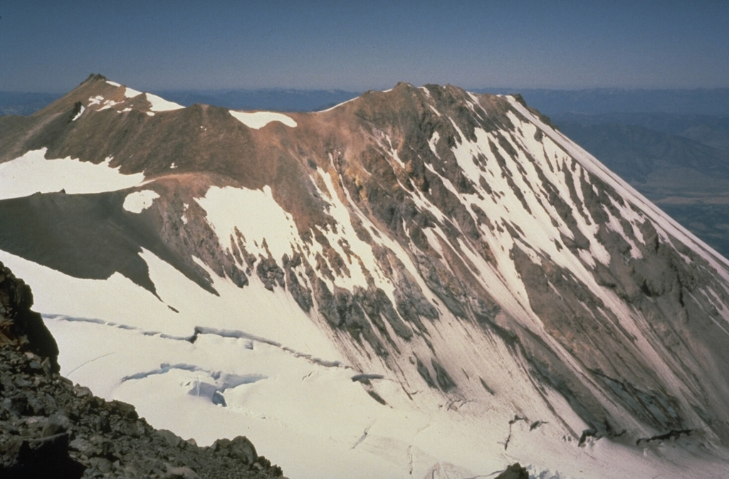 Shastina forms the west flank of Mount Shasta with Whitney Glacier at its base. It is composed of overlapping lava flows and domes. Emplacement of the Shastina domes about 9,700-9,400 years ago was accompanied by pyroclastic flows and lava flows that traveled long distances down its flanks. Photo by Bill Chadwick, 1981 (U.S. Geological Survey).