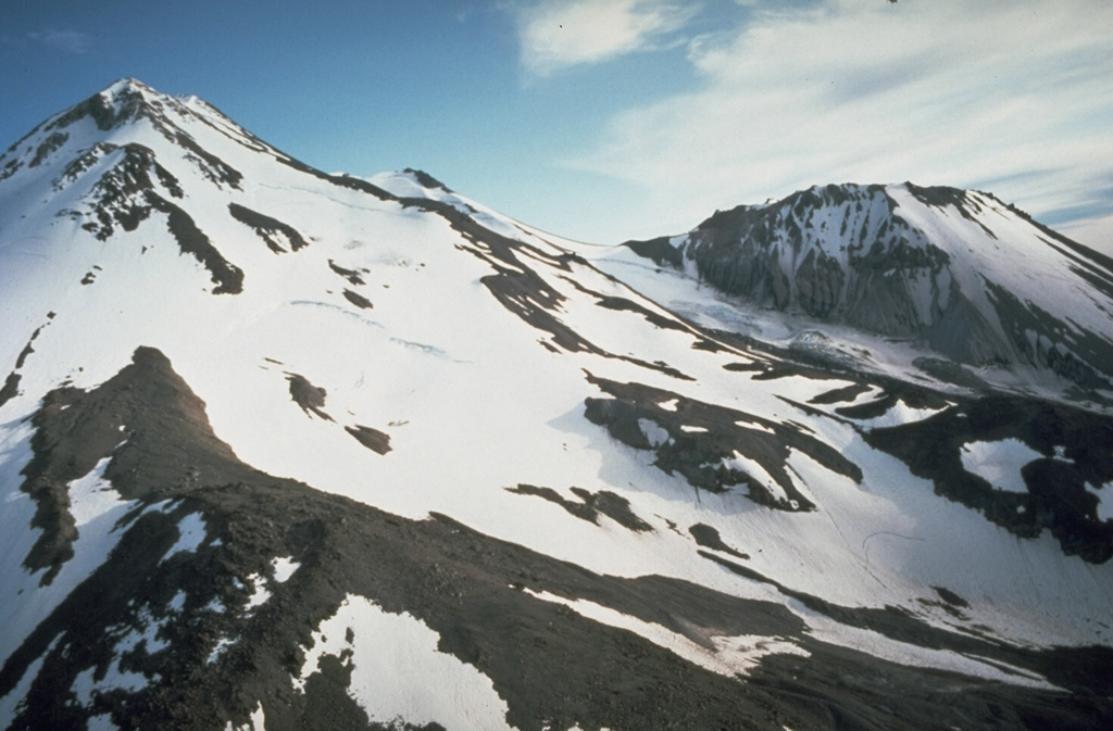 The prominent lava dome of Shastina, seen here on the right from the north, formed on the west flank of Shasta between about 9,700 and 9,400 years ago. The Shastina summit contains several overlapping domes. Hotlum cone to the left forms the main summit of Shasta and is likely younger than Shastina. Photo by Dan Dzurisin, 1982 (U.S. Geological Survey).