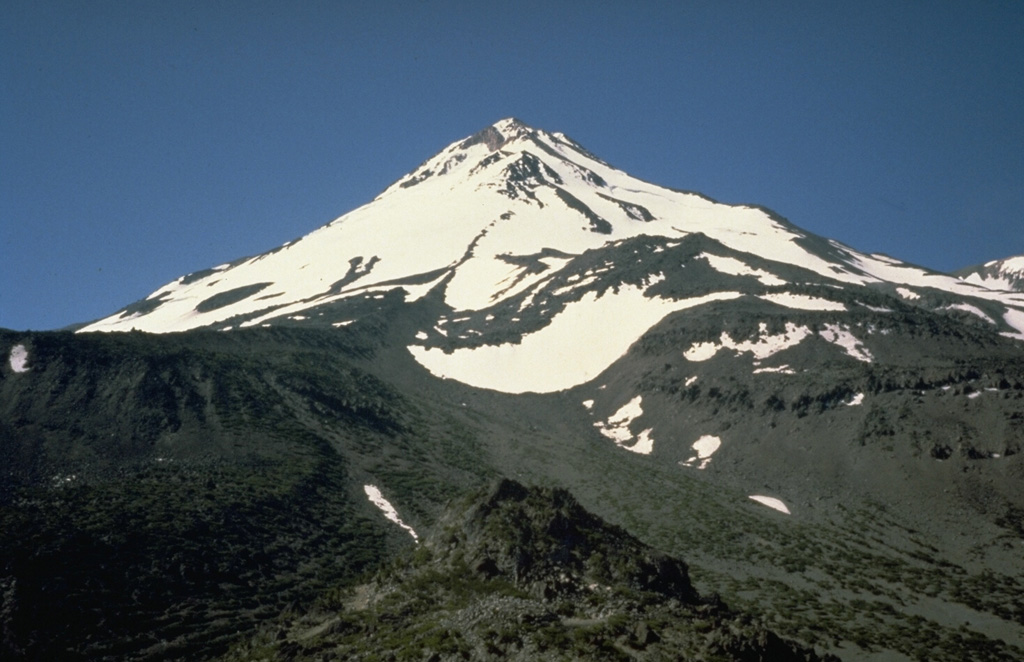 Hotlum cone, seen here from the NW, forms the main summit of Mount Shasta and is one of the largest Cascade Range volcanoes. Hotlum is composed of several overlapping edifices and formed during the Holocene. Photo by Bill Chadwick, 1981 (U.S. Geological Survey).