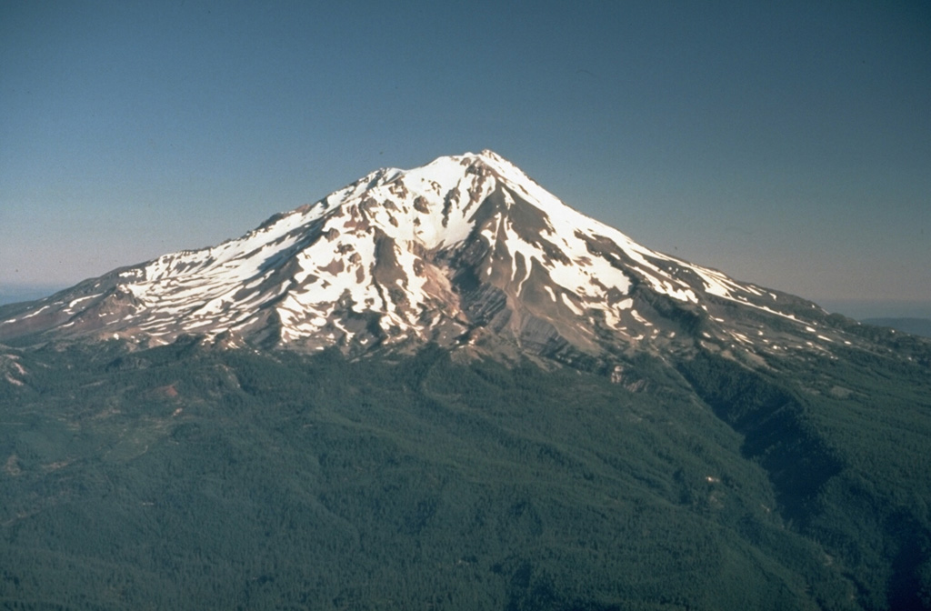 Mount Shasta in northern California, seen here from the SE, is one of the largest of the Cascades volcanoes and is constructed of at least four overlapping edifices. Hotlum cone (forming the summit), along with the Shastina and Black Buttes lava domes, were all constructed during the Holocene. Photo by Lyn Topinka, 1984 (U.S. Geological Survey).