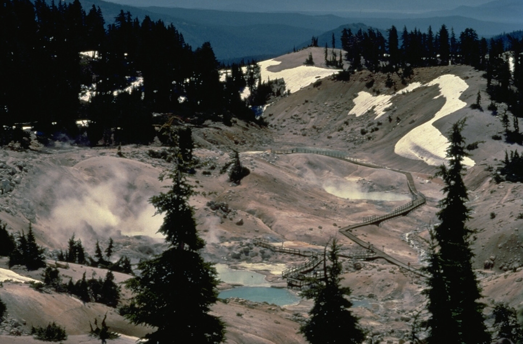 Bumpass Hell, the largest hydrothermal area at Lassen volcano, located south of Lassen Peak, contains steaming fumaroles and mudpots.  It was named after its discoverer, a noted hunter and mountain man who suffered severe burns when he broke through the thin crust of the thermal area. Copyrighted photo by Katia and Maurice Krafft, 1989.