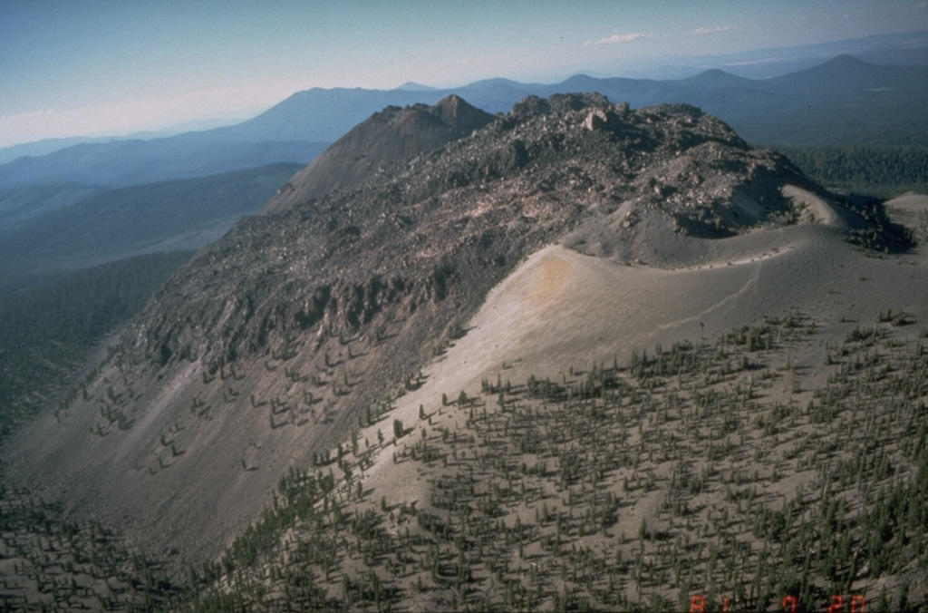 The Chaos Crags lava dome complex on the north flank of Lassen Peak, seen here from the south, was formed at the end of an eruptive period about 1100-1000 years ago.  A tephra ring from associated explosive eruptions forms the light-colroed area at the middle right. Photo by Dan Dzurisin, 1981 (U.S. Geological Survey).