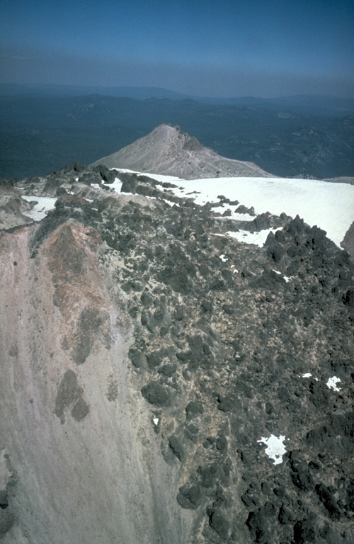 In May 1915, a year after the start of the eruption, lava flowed through low points in the eastern and western crater rims and descended the upper flanks. The western flow shown in this photo reached about 500 m down the flank. On 19-20 May 1915 the eastern flow fragmented and mixed with snowmelt, forming a debris flow that traveled 35 km down Lost Creek and Hat Creek valleys, destroying bridges and farm buildings. Photo by Bill Chadwick, 1981 (U.S. Geological Survey).