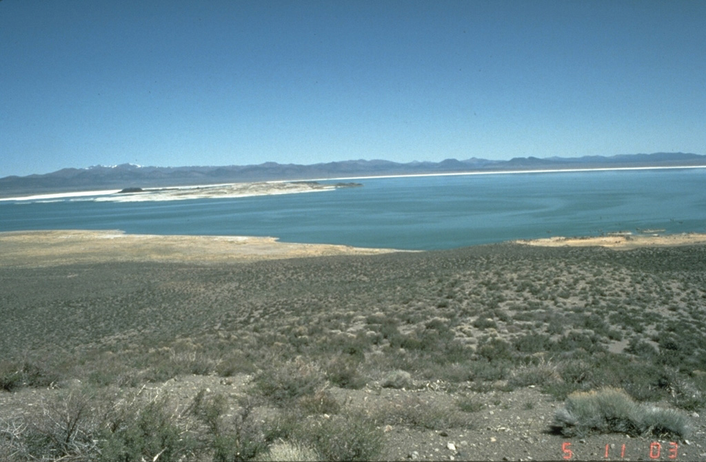 Paoha Island in the center of Mono Lake at the left is seen from the flanks of Panum Crater on the south, at the northern end of the Mono Craters.  The Mono Lake volcanic field consists of multiple volcanic vents on the northern shore of the lake and on Paoha and Negit Islands, which were last active a few hundred years ago. Photo by Dan Dzurisin, 1982 (U.S. Geological Survey).