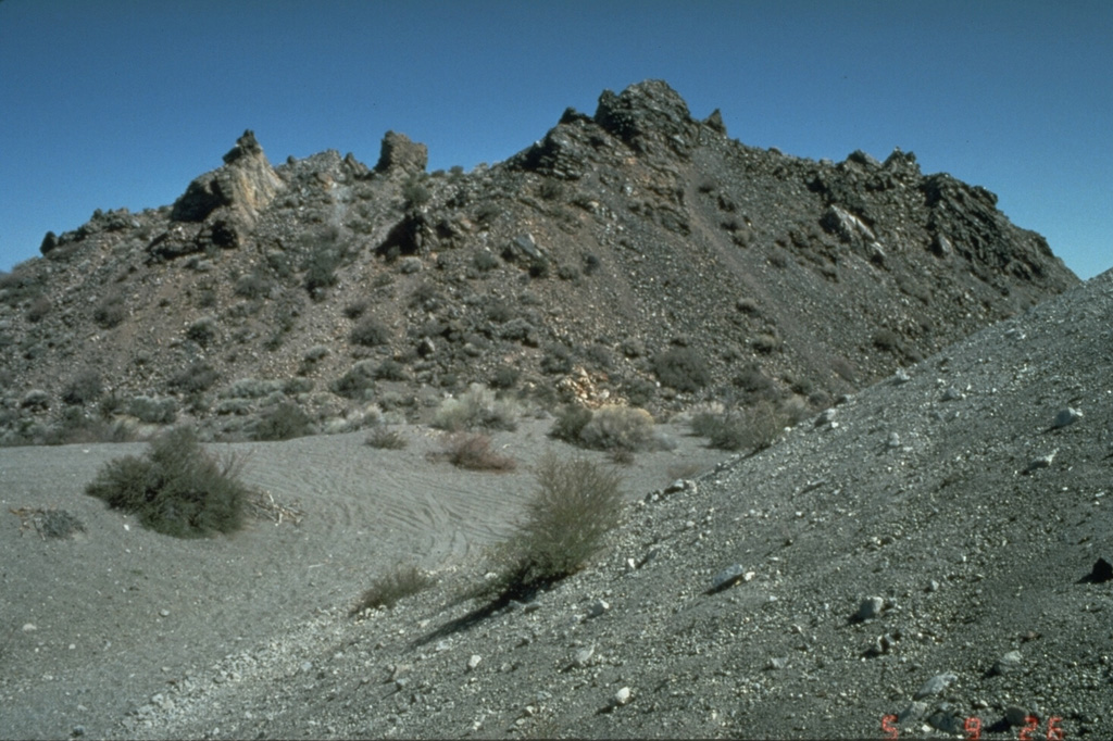 The hackly surfaced Panum lava dome, filling a tephra ring at the northern end of the Mono Craters chain, was one of five rhyolitic lava domes and flows emplaced at the end of a major eruption about 600 years ago.  The eruption, which began with powerful plinian explosive eruptions accompanied by pyroclastic flows and surges, occurred just a year or two prior to another major eruption at Inyo Craters to the south. Photo by Dan Dzurisin, 1982 (U.S. Geological Survey).