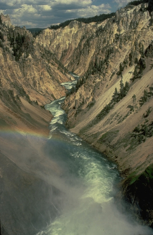 The brilliant hues of the Grand Canyon of the Yellowstone are cut through hydrothermally altered rhyolitic lava flows erupted within Yellowstone caldera.  The Yellowstone volcanic field was created during three volcanic cycles over the past 2 million years, each culminating in a voluminous explosive eruption creating a large caldera.  Yellowstone's impressive array of hot springs and geysers, part of the most vigorous hydrothermal system in the world, is evidence of a still-active magmatic system. Copyrighted photo by Katia and Maurice Krafft, 1984.