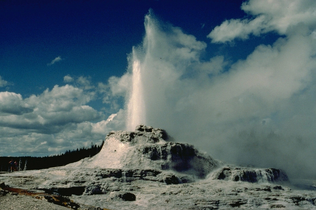 Castle Geyser in Yellowstone's Upper Geyser Basin erupts from a 4-m-high, 12-m-wide sinter mound.  Eruptions of Castle Geyser are typically sustained for an hour or more. Copyrighted photo by Katia and Maurice Krafft, 1984.
