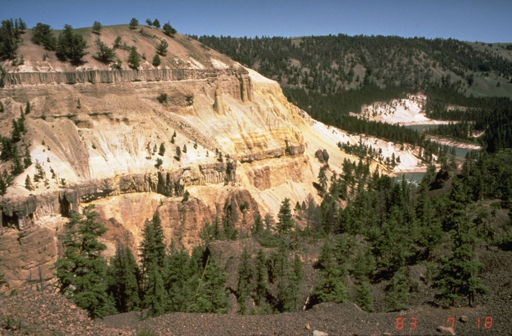 The two dark horizontal bands in the cliff on the left near Tower Junction in NE Yellowstone are lava flows that display prominent columnar jointing.  The base of the cliff exposes volcanic materials of the Absaroka Formation.  The light-colored rocks between the basaltic lava flows are stream-gravel sediments.  The top of the hill consists of lake sediments. Photo by Dan Dzurisin, 1983 (U.S. Geological Survey).