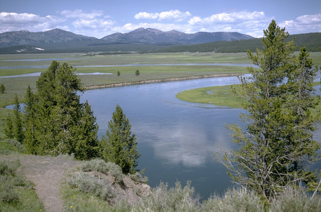 The Yellowstone River slowly meanders through the Hayden Valley, which is underlain by glacial lake sediments capping thick lava flows on the floor of Yellowstone caldera.  Mount Washburn, in the center background, is part of an ancient Absaroka volcano that predates the caldera.  The northern margin of the Yellowstone caldera lies at the base of the mountain range. Photo by Lee Siebert, 1974 (Smithsonian Institution).