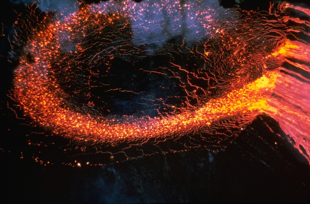 Lava flows from a fissure that opened on 5 March 1965 extended 13 km from Makaopuhi to beyond Nāpau crater. The lava cascaded into Makaopuhi crater, forming a lava lake more than 100 m deep. Photo by Tom Wright, 1965 (U.S. Geological Survey).