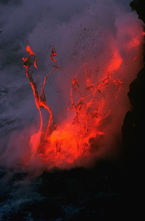 Explosions like this can occur when lava flows enter the ocean. This photo, taken along the Kalapana ocean entry point on 27 November 1989, documents a common occurrence during the East Rift Zone eruption of Kilauea that began in 1983 and ended in 2018. Photo by J.D. Griggs, 1989 (U.S. Geological Survey).