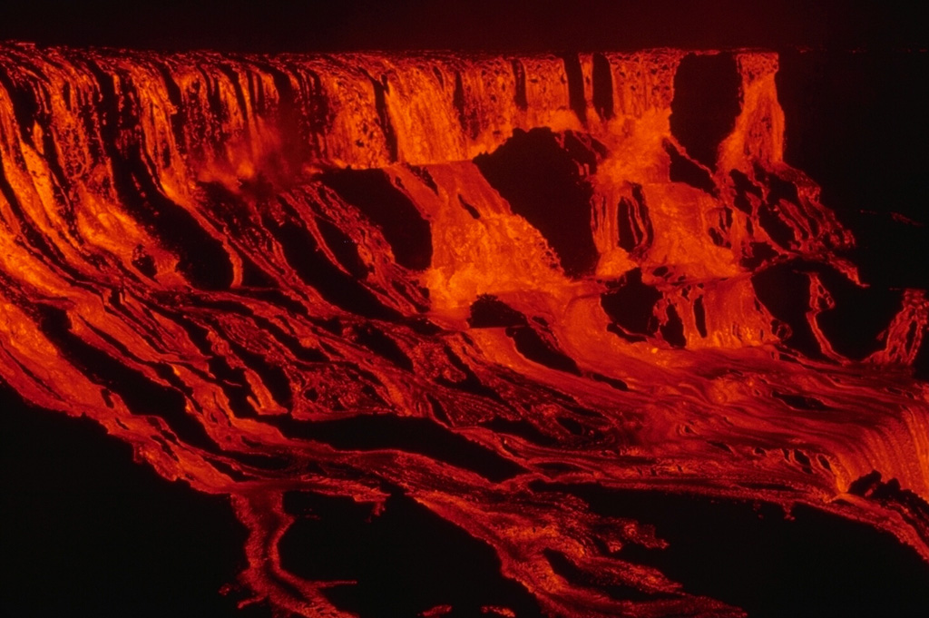A cascade of lava flows down the walls of Alae crater on 5 August 1969. During the course of the 1969-1974 Mauna Ulu eruption lava entirely filled both Alae and nearby Aloi craters. Lava flows from this eruption traveled 12 km to the sea. Photo by Jeffrey Judd, 1969 (U.S. Geological Survey).
