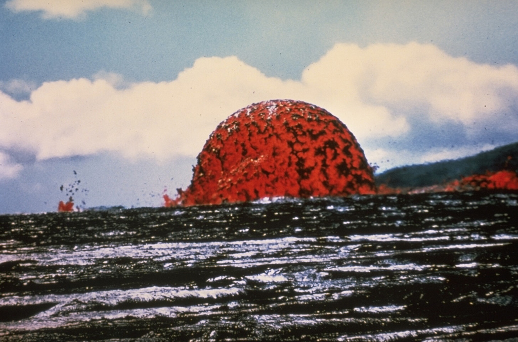 A dome fountain reached heights of about 20 m for hours on 11 October 1969. This unusual activity, produced by fountaining from a circular, vertical conduit at relatively constant gas pressures, occurred early during the Mauna Ulu eruption. This East Rift Zone eruption lasted from 1969 until 1974. Photo by Jeffrey Judd, 1969 (U.S. Geological Survey).