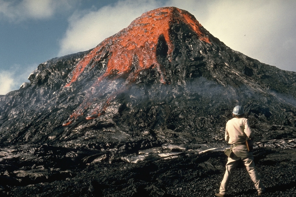 This eruption was observed by Hawaiian Volcano Observatory volcanologist Jack Lockwood on 28 February 1974, near the end of the 5-year-long Mauna Ulu eruption. As the erupting lava solidifies around the vent the feature gets progressively larger. Photo by Robin Holcomb, 1974 (U.S. Geological Survey).