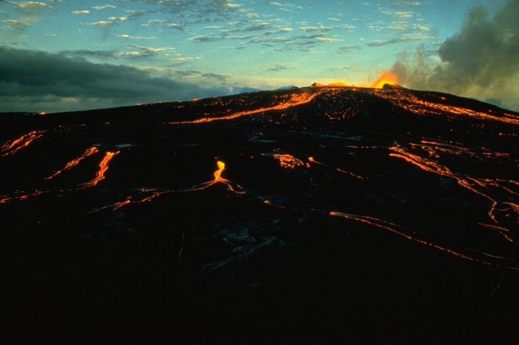 Pahoehoe lava flows on Kilauea are fed from low lava fountains in June 1974, near the end of the major 1969-74 Mauna Ulu eruption. This final stage of the eruption ended on 22 July 1974 after producing a lava lake, lava fountains up to 80 m high, and lava flows. Photo by Robin Holcomb, 1974 (U.S. Geological Survey).