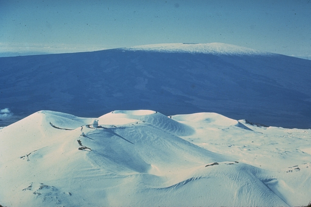 Hawaii's two largest shield volcanoes are Mauna Loa (in the background to the S) and Mauna Kea. Mauna Loa has the classic low-angle profile of a shield volcano constructed by repetitive eruptions of thin, overlapping lava flows. Mauna Kea’s profile has been modified by late-stage explosive eruptions that constructed a series of cones at the summit. Photo by Don Swanson (U.S. Geological Survey).