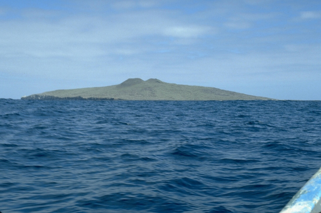 Isla San Martín, 6 km off the west coast of Baja California, is the westernmost volcano of the San Quintín volcanic field and the only one that is located offshore. The 2-km-wide island is a shield volcano capped by scoria cones that reach 230 m above sea level. Wave erosion has truncated part of the volcano, forming the sea cliffs seen at the left on the S side of the island. Photo by Jim Luhr, 1990 (Smithsonian Institution).