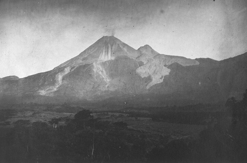 This 11 March 1901 photo from the east shows a small plume from the summit of Colima during a period of intermittent mild explosive eruptions that began in 1893. This eruption included the emission of small lava flows from the summit during 1895-1902. The unvegetated lava flows descending from El Volcancito, the dome on the NE (right) flank, were produced during its formation in 1869. Photo by José Ma. Arreola, 1901 (courtesy of Julian Flores, University of Guadalajara).
